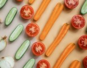 Fresh vegetables and whole foods arranged on a table