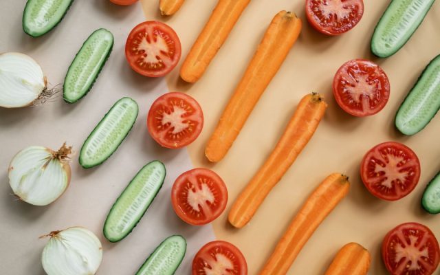 Fresh vegetables and whole foods arranged on a table