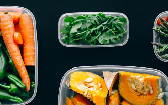 Healthy vegetables stored in plastic containers for fresh and nutritious meals.