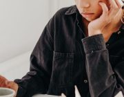 Woman sitting quietly and reflecting, looking calm and thoughtful