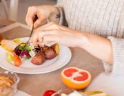Woman enjoying a fresh colorful vegetable salad