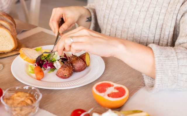 Woman enjoying a fresh colorful vegetable salad
