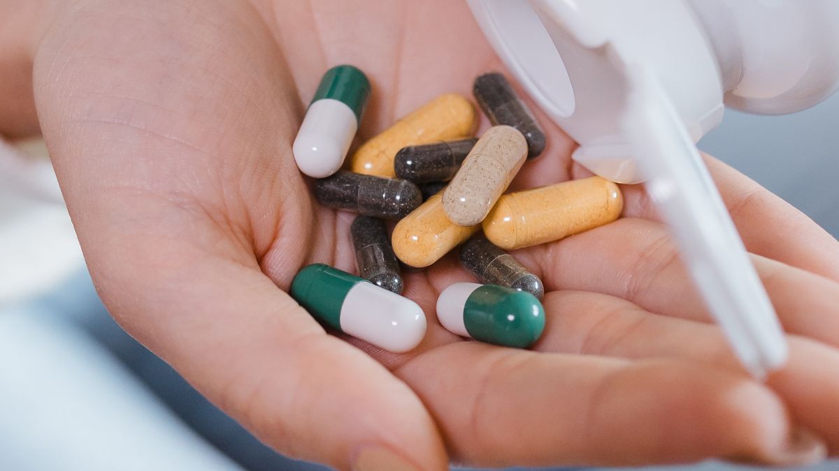 Woman holding pills, one of the most common hormonal birth control options