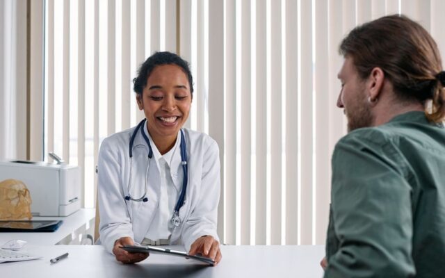 Doctor talking with a patient about birth control options in a bright clinic