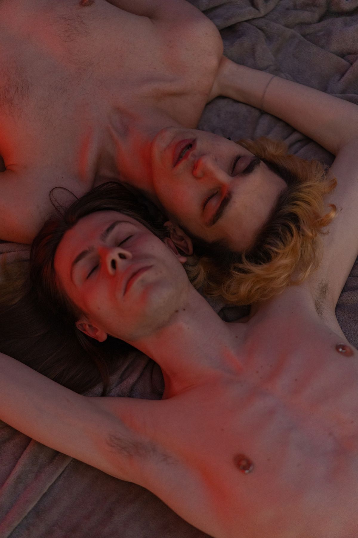 Couple sleeping peacefully on their sides in bed