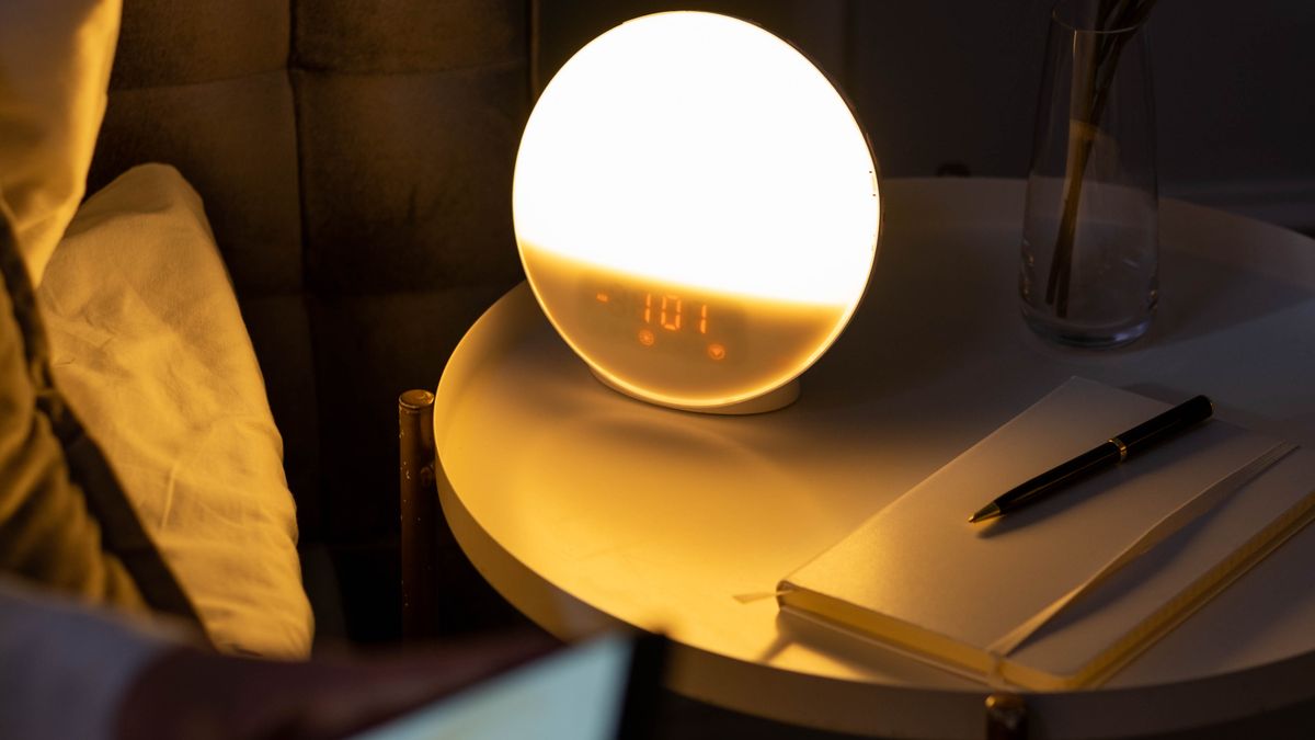 An alarm clock on a bedside table in the morning