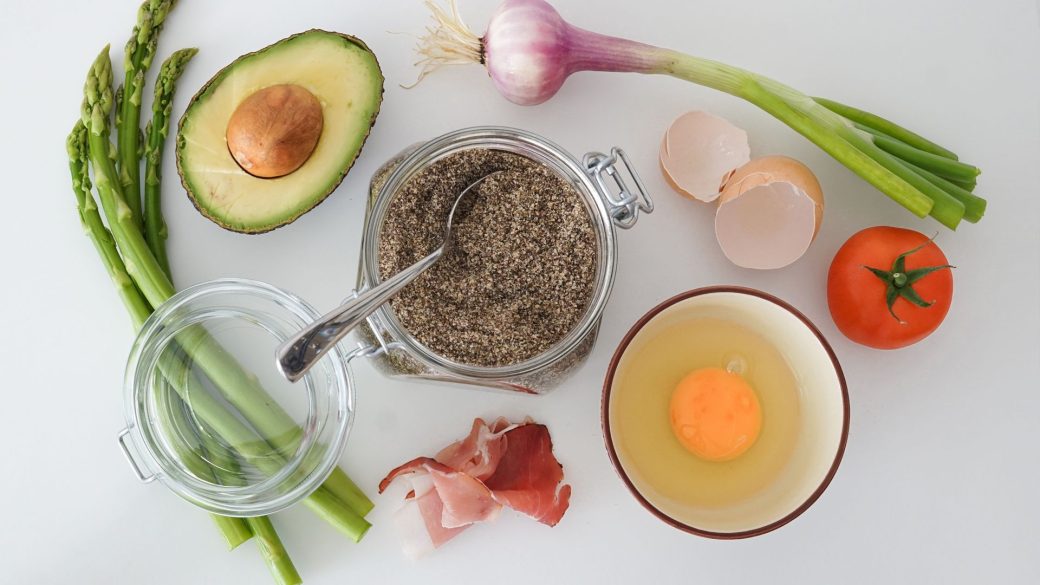 Flat lay of fresh vegetables, avocado and egg for healthy weight loss eating