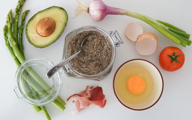 Flat lay of fresh vegetables, avocado and egg for healthy weight loss eating