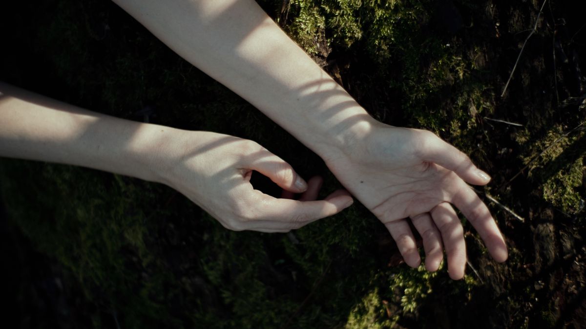 Woman recovering from burnout relaxing outdoors in a forest
