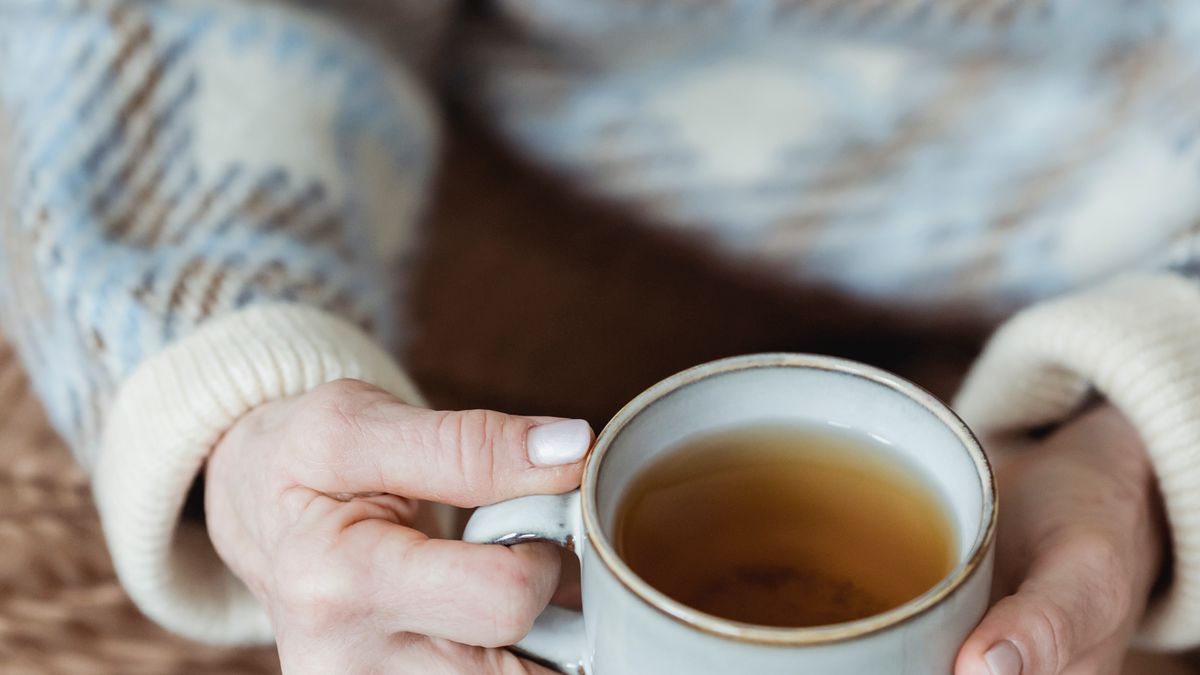 Woman drinking herbal tea in the evening instead of alcohol for better sleep