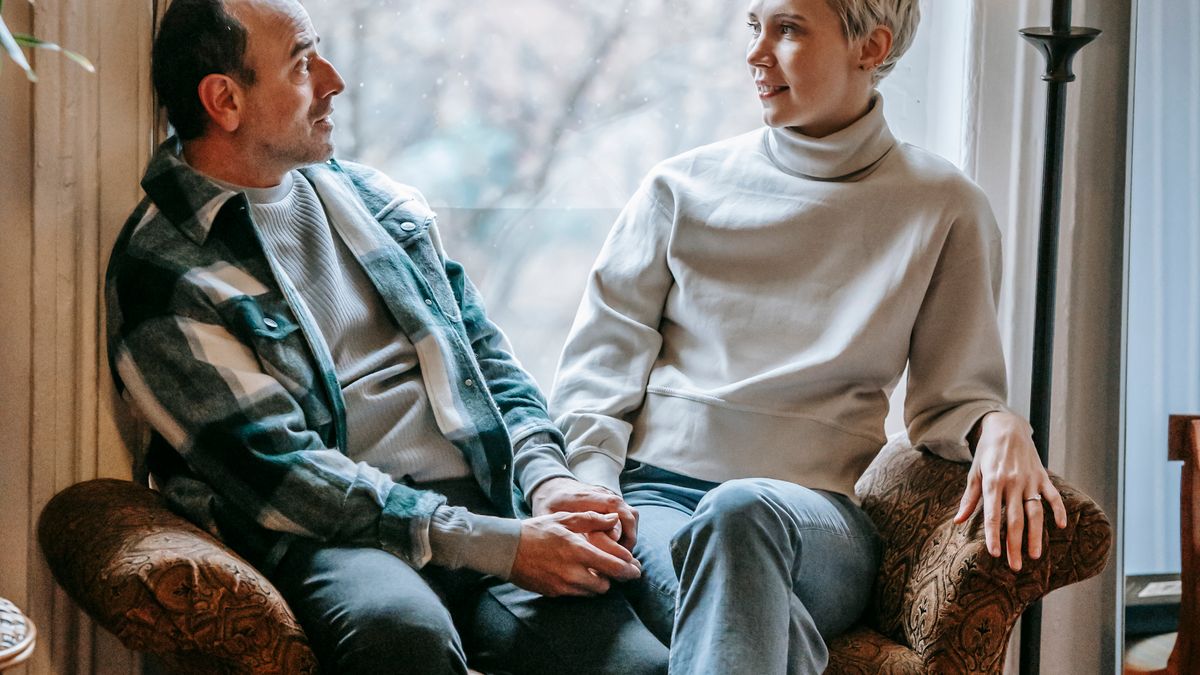 Couple talking openly on the couch about how often they have sex