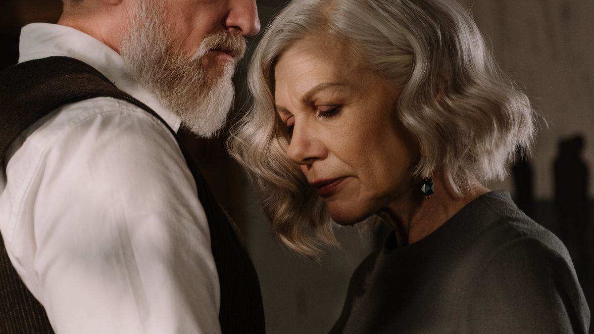 Older couple embracing warmly at home