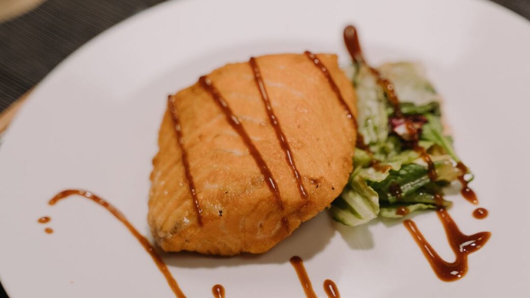 Grilled salmon fillet on a plate, one of the richest food sources of omega-3 fatty acids