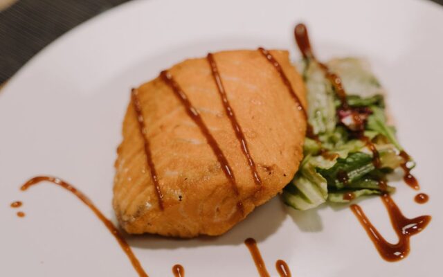 Grilled salmon fillet on a plate, one of the richest food sources of omega-3 fatty acids