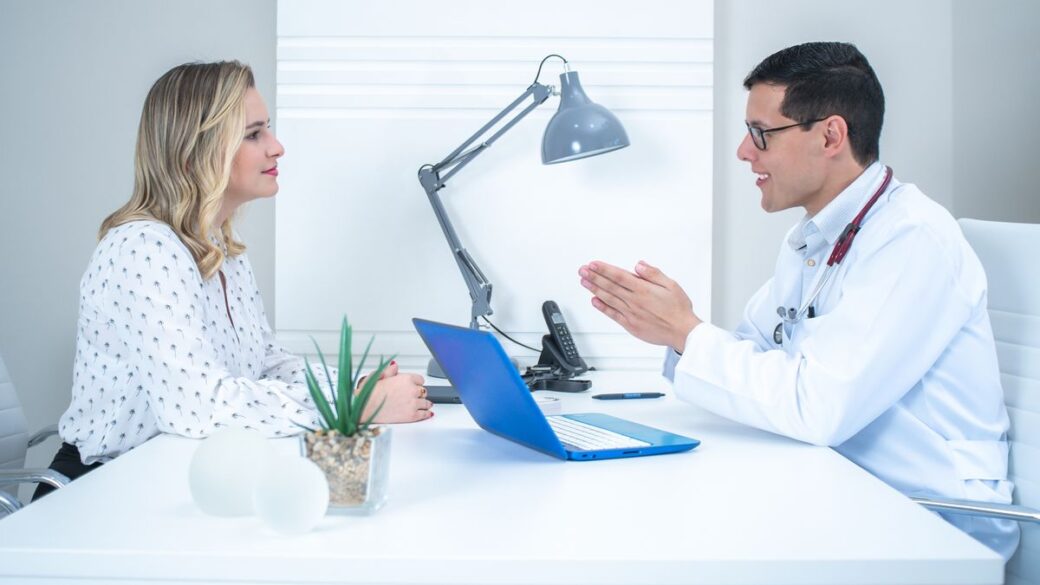 Doctor talking with an adult woman patient about HPV during a consultation