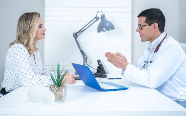 Doctor talking with an adult woman patient about HPV during a consultation