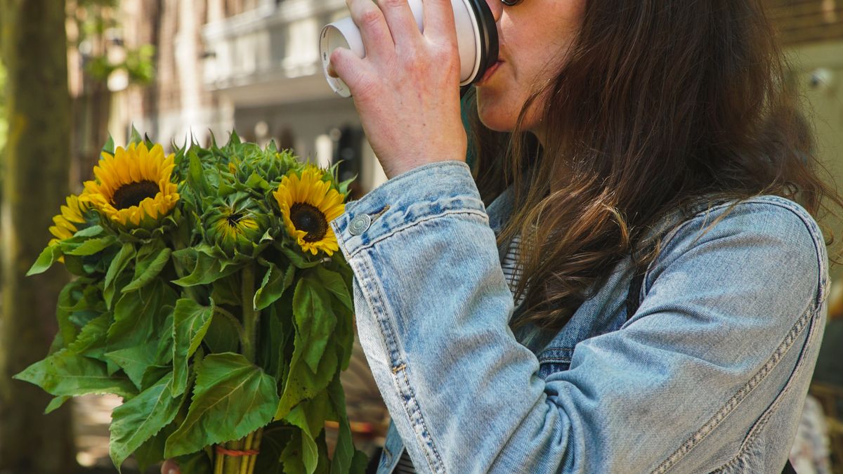 Woman drinking a morning cup of coffee containing about 95 mg of caffeine