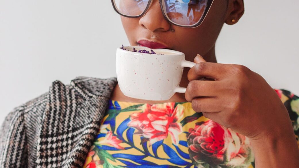 Woman drinking a cup of coffee, thinking about how much caffeine is too much