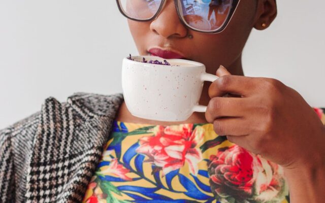 Woman drinking a cup of coffee, thinking about how much caffeine is too much