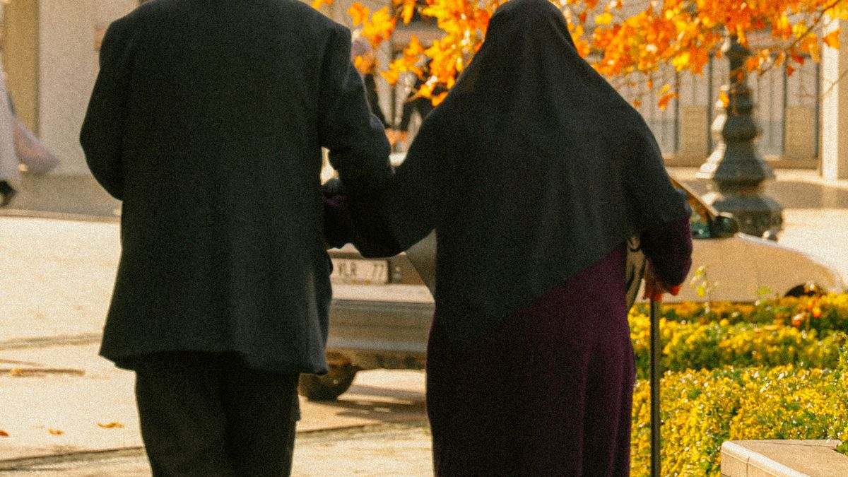 Older couple walking outdoors for daily movement and weight loss after 40