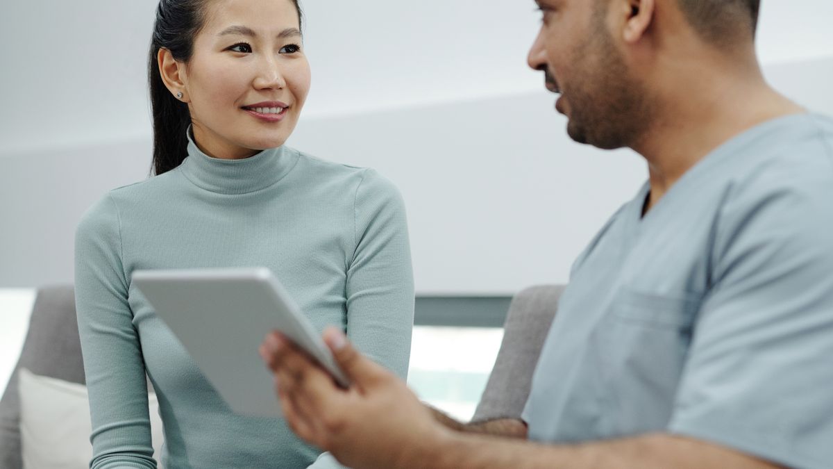 Woman discussing HPV screening options with her healthcare provider in a clinic