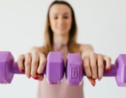 Woman over 40 holding dumbbells, strength training for weight loss after 40