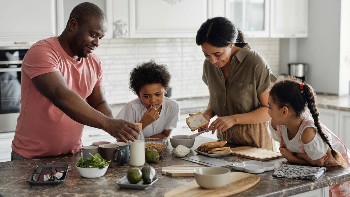Family making breakfast together in the kitchen with B12-rich foods
