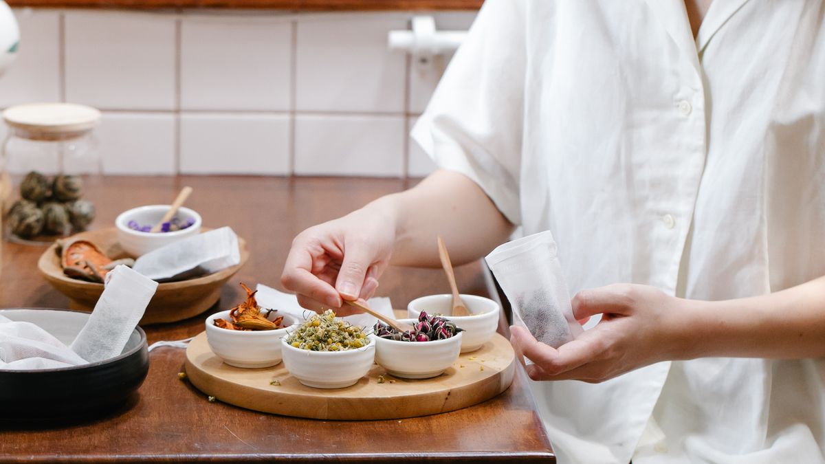 Woman preparing ingredients in her kitchen as part of a weight maintenance routine