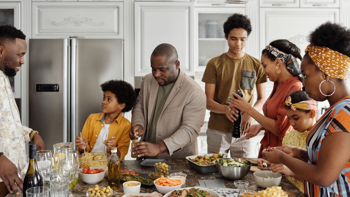 Family preparing a fresh meal together in a home kitchen
