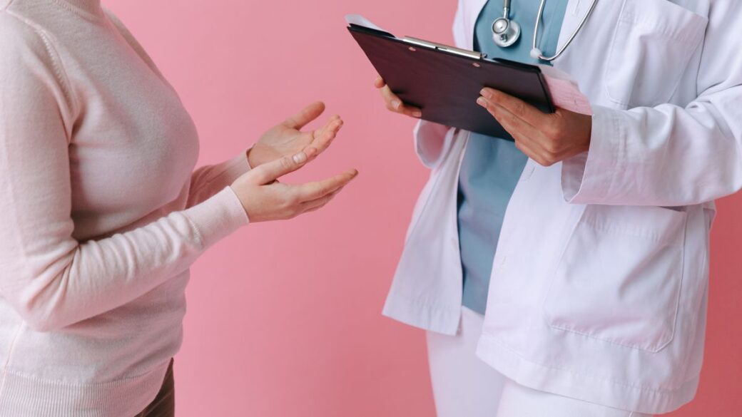 Doctor consulting an adult patient during a routine sexual health check-up
