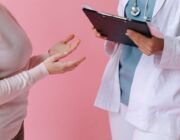 Doctor consulting an adult patient during a routine sexual health check-up