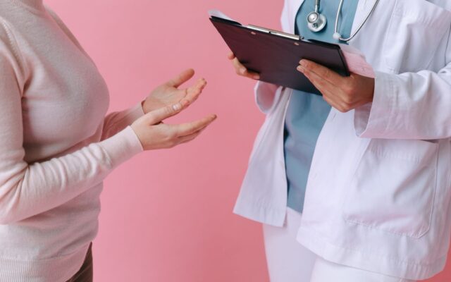 Doctor consulting an adult patient during a routine sexual health check-up
