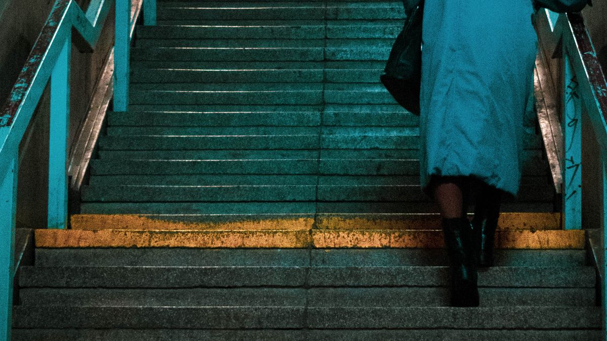 Woman climbing stairs briskly as a short burst of everyday exercise