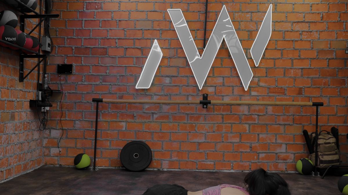 Woman holding a plank during a 10-minute strength workout on a mat