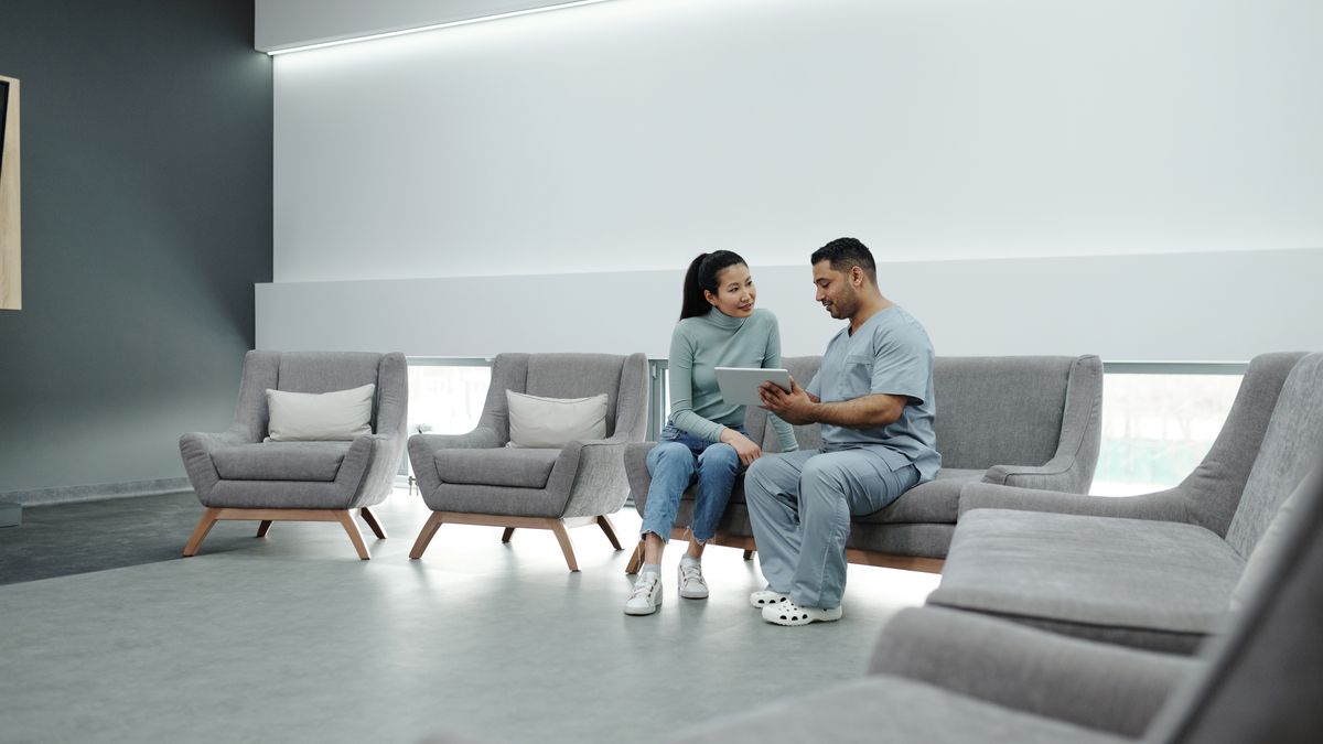Clinician discussing STI testing results with a patient during a confidential consultation