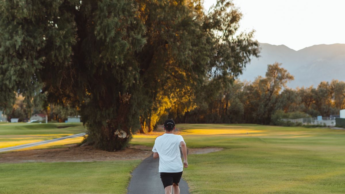 Woman jogging along a park footpath as sustainable exercise to avoid weight regain