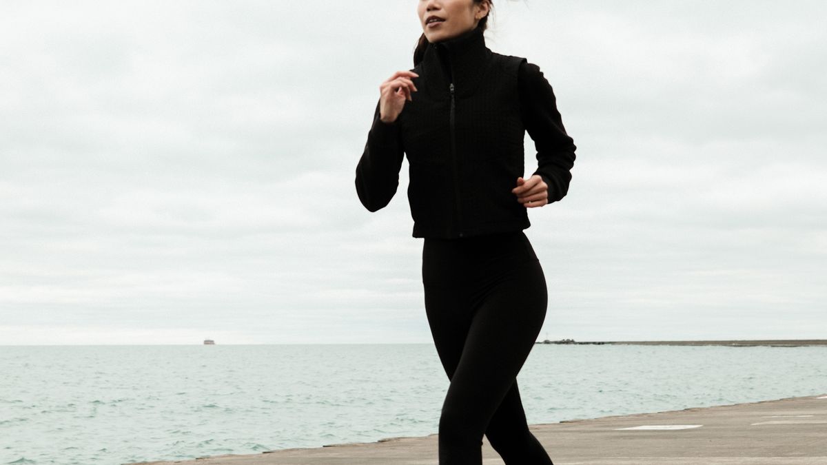 Woman doing an easy zone 2 jog outdoors at a conversational pace